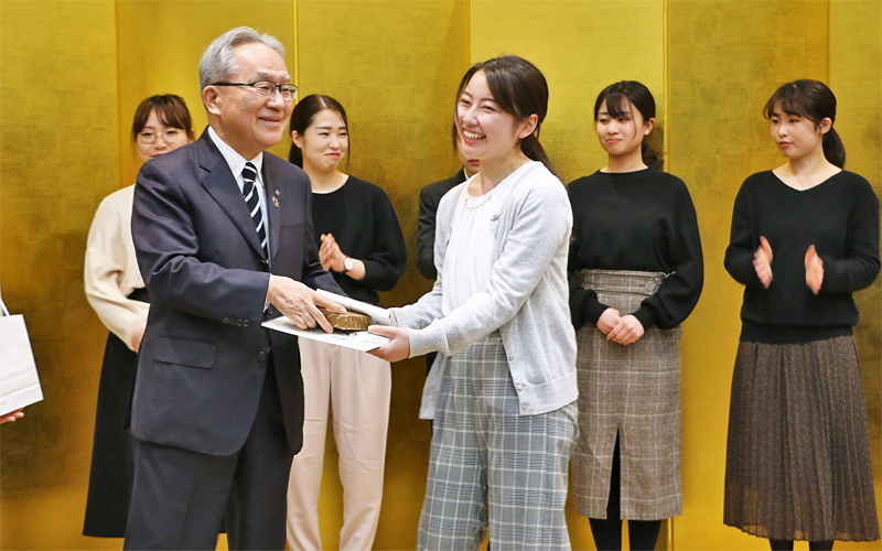 東邦銀行の新成人女性行員に直接記念品を贈呈する北村清士頭取（手前左、１月７日、東邦銀行本店）