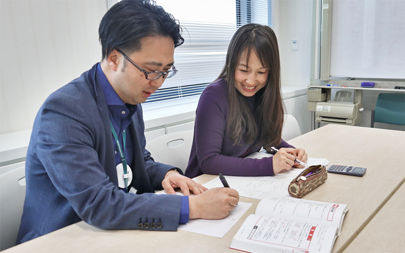 正社員への転換試験に向けて上司の尾川豪介広報室長（左）と勉強する契約社員。試験に合格し４月から正社員に（１月６日、あいおいニッセイ同和損保本社会議室）