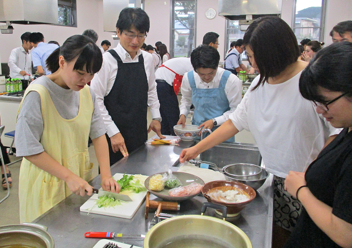 女志リーダーズが企画・運営した宮崎県日南地方の郷土料理「魚うどん」作り体験。中央は油津支店の石崎智則支店長(「まなびピア」調理室)