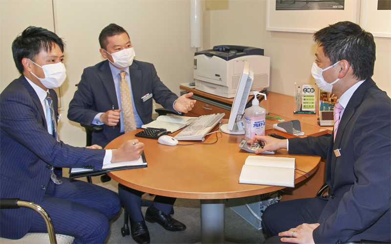 渉外担当者のチームリーダーと富裕層への推進手法を確認する中田哲也支店長(中央、7月2日