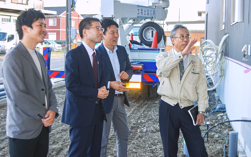 現在建設中で2022年5月に竣工予定の新工場内についてエムティー物産の森英晴代表取締役(右)から説明を受ける内藤義晴支店長(左から2人目)と中部カンパニー、静銀経営コンサルの担当者(11月10日、エムティー物産)