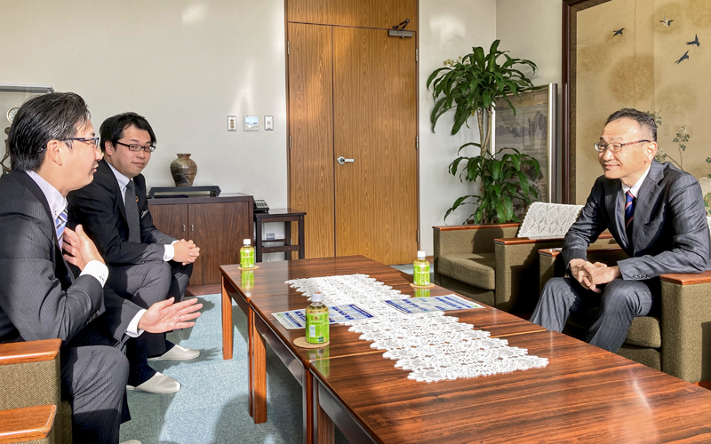 SDGsコンサル契約を結んだ日本ポリスター社の高井文彦社長(右)と情報交換する植田恵介支店長(手前、2022年12月26日、同社)